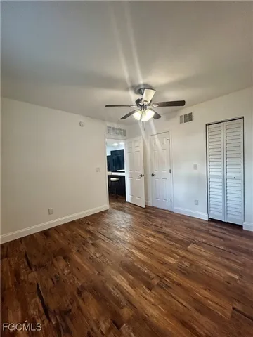 a view of a room with wooden floor
