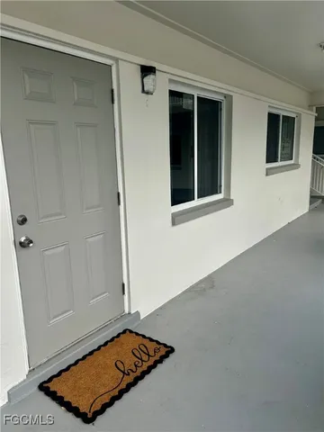 a view of swimming pool with a yard and table and chairs under an umbrella