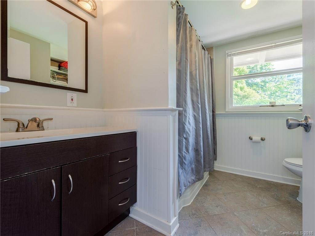 525 Scaleybark Road Charlotte, NC 28209 - Photo 16 of 24 a bathroom with a sink a toilet and a mirror
