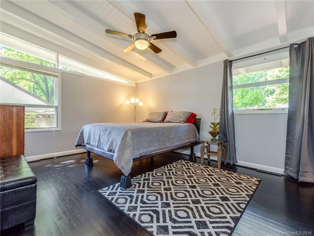 525 Scaleybark Road Charlotte, NC 28209 - Photo 17 of 24 a bedroom with a bed and wooden floor