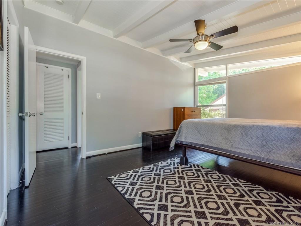525 Scaleybark Road Charlotte, NC 28209 - Photo 18 of 24 a bedroom with a bed and a chandelier