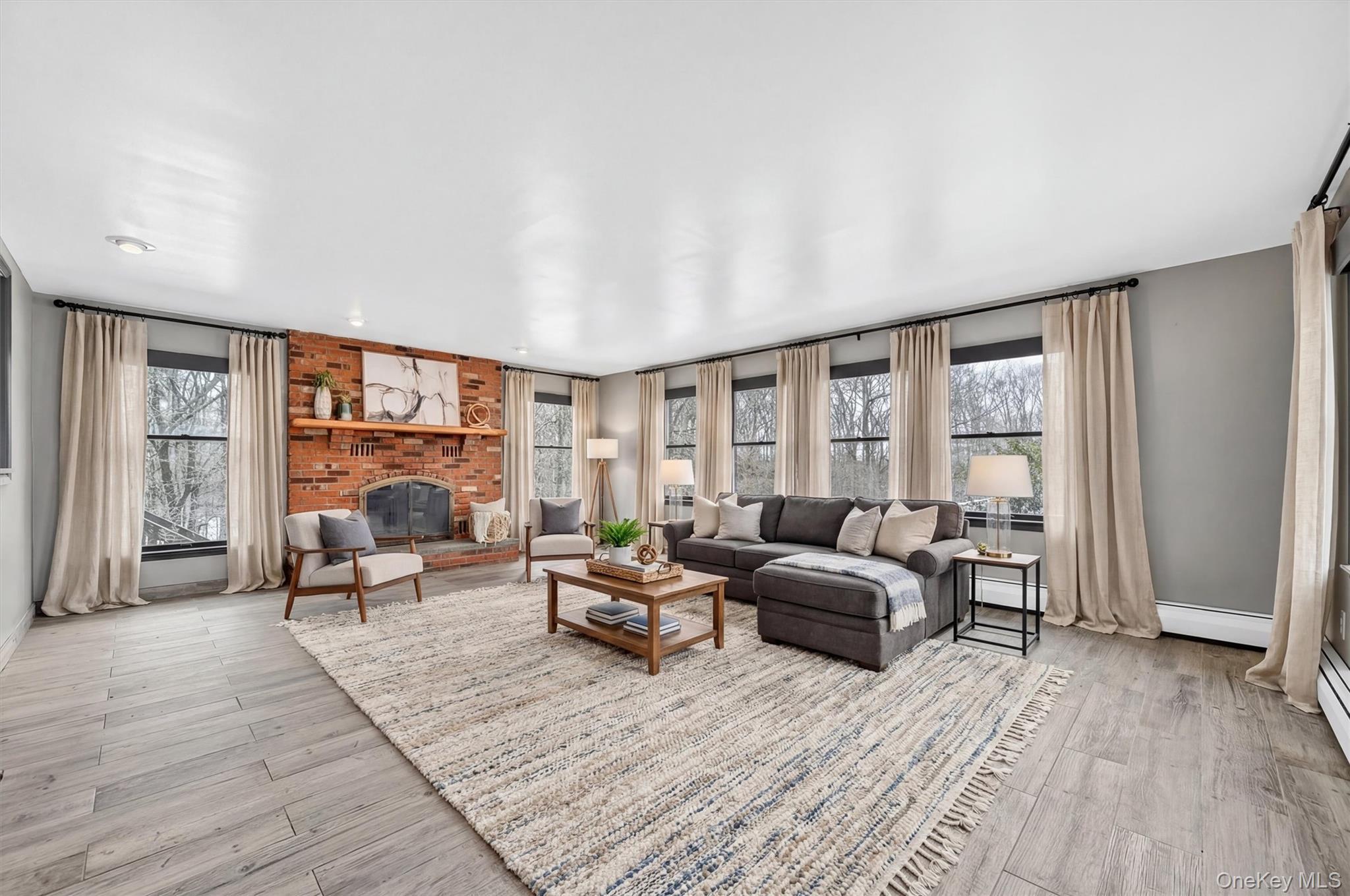 285 Hill Road Goshen, NY 10924 - Photo 21 of 49 Large and warm sunken family room with plenty of windows and a brick fireplaceVirtually Staged