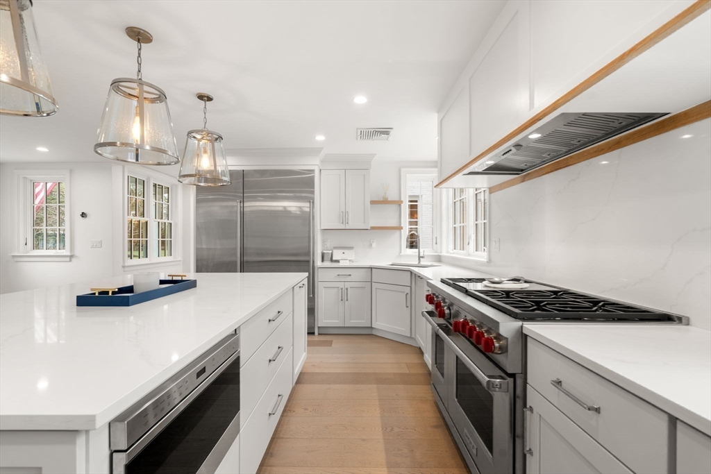 389 Grove Street Needham, MA 02492 - Photo 10 of 40 a kitchen with stainless steel appliances a sink stove and cabinets
