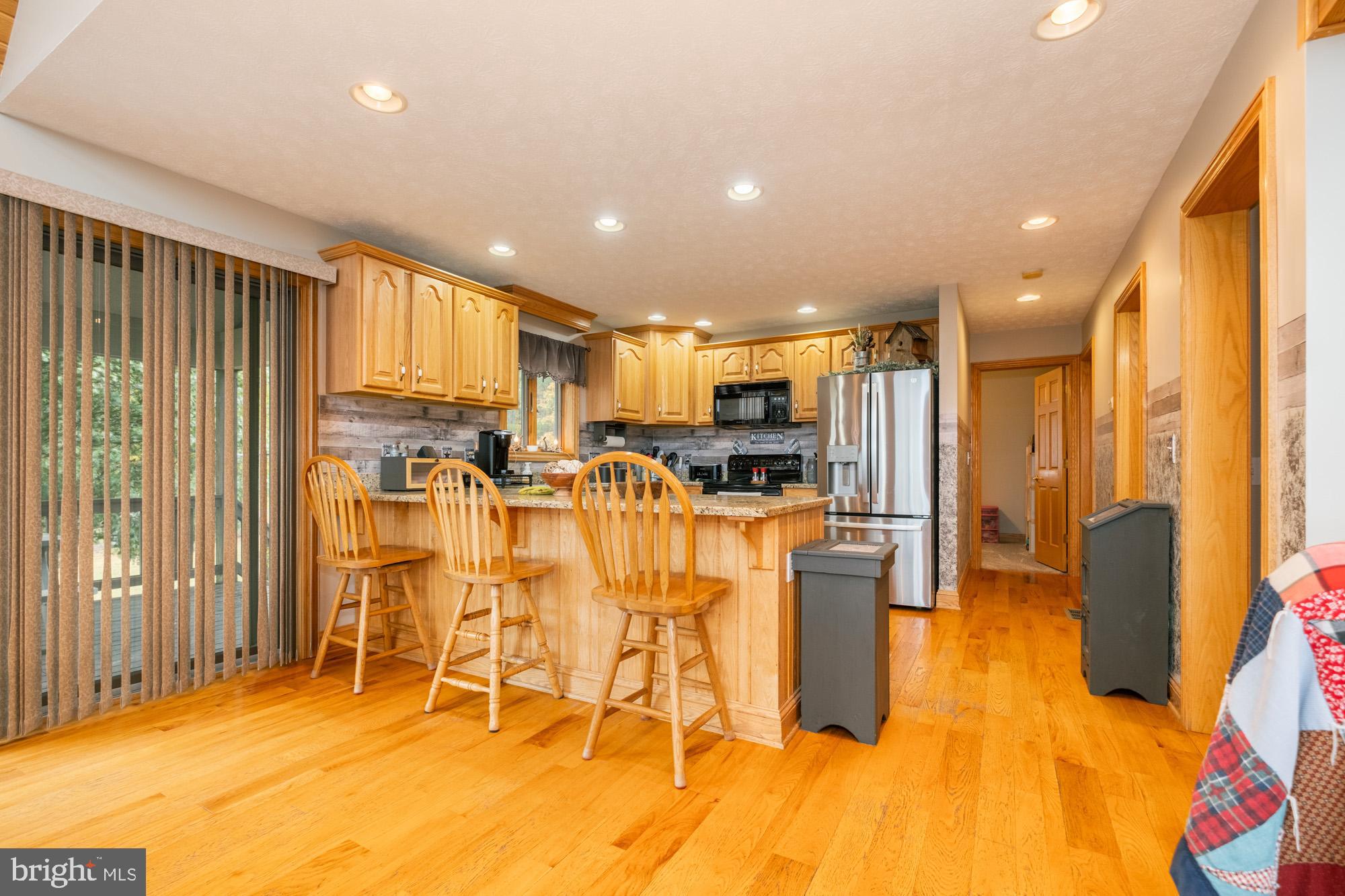 1875 Pysell Crosscut Road Oakland, MD 21550 - Photo 25 of 67 a kitchen with stainless steel appliances kitchen island granite countertop a refrigerator and microwave