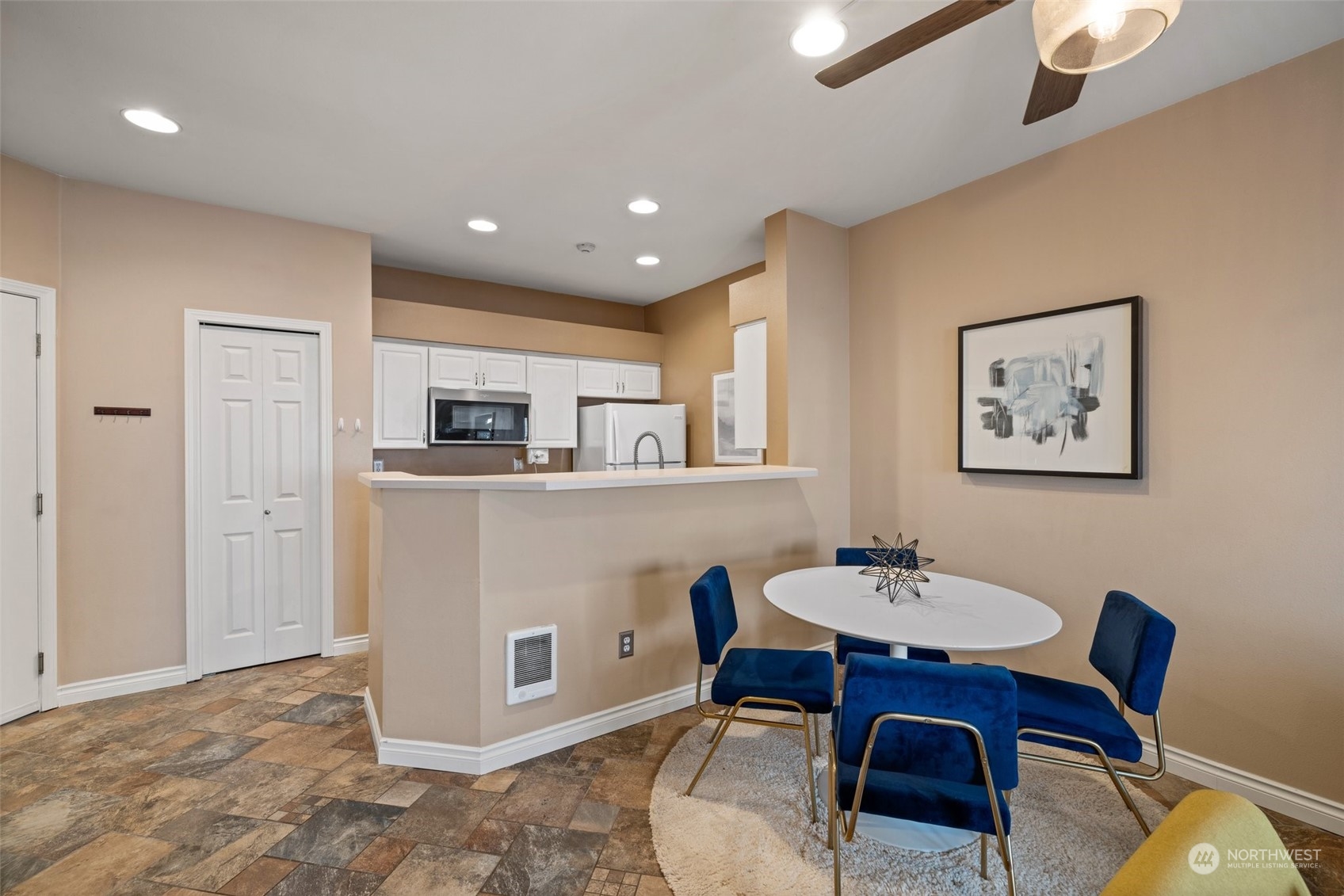 23908 Bothell Everett Highway, Unit B203 Bothell, WA 98021 - Photo 7 of 15 a living room with stainless steel appliances kitchen island granite countertop furniture a dining table and chairs