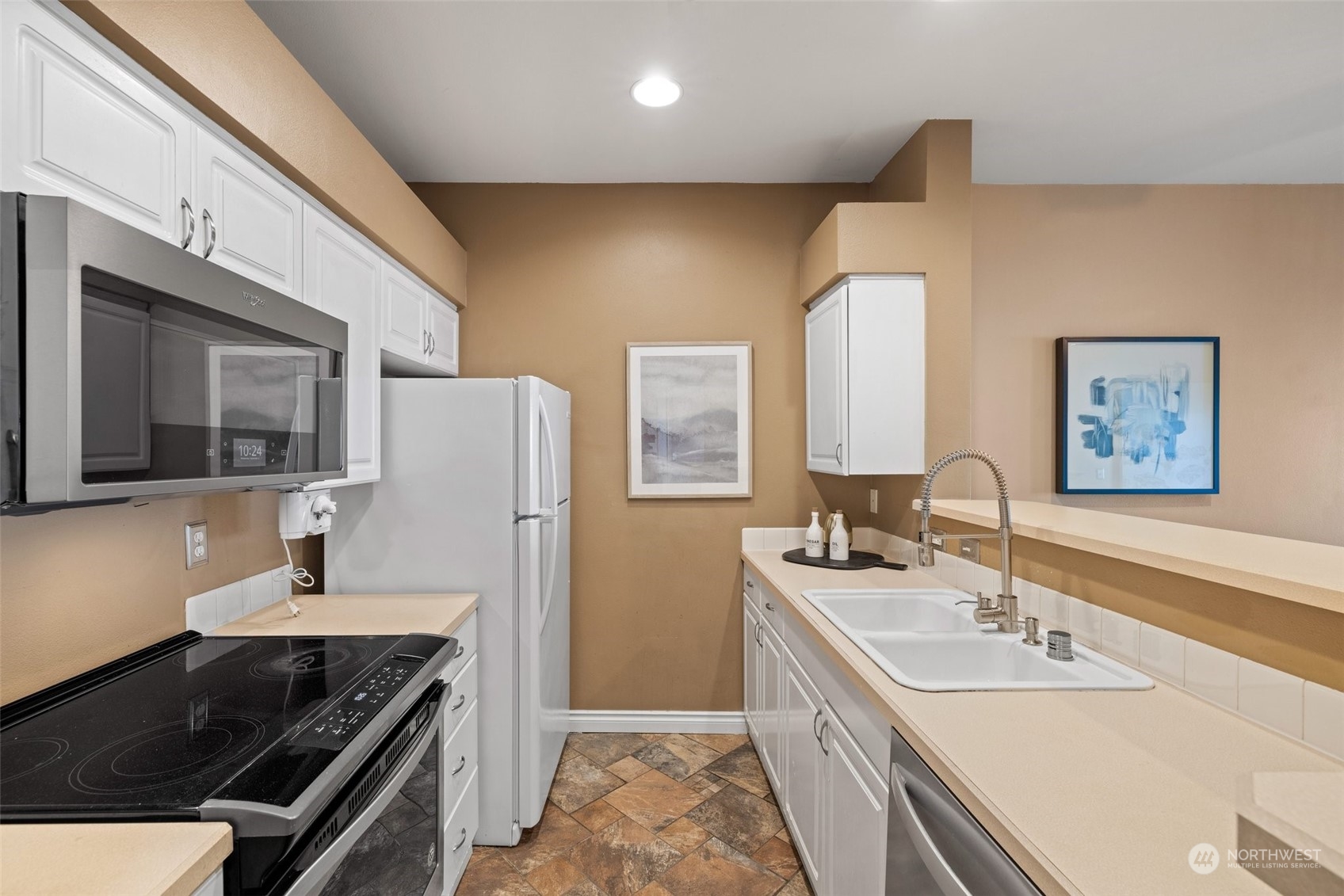 23908 Bothell Everett Highway, Unit B203 Bothell, WA 98021 - Photo 8 of 15 a kitchen with a sink stove and refrigerator
