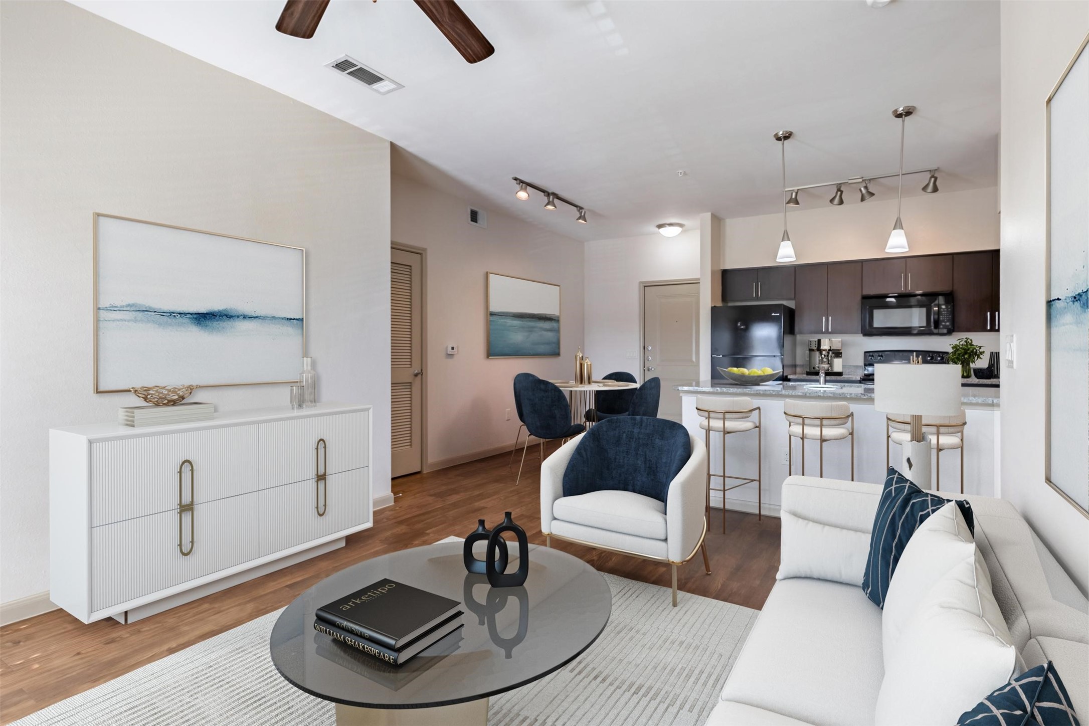a living room with furniture and a wooden floor