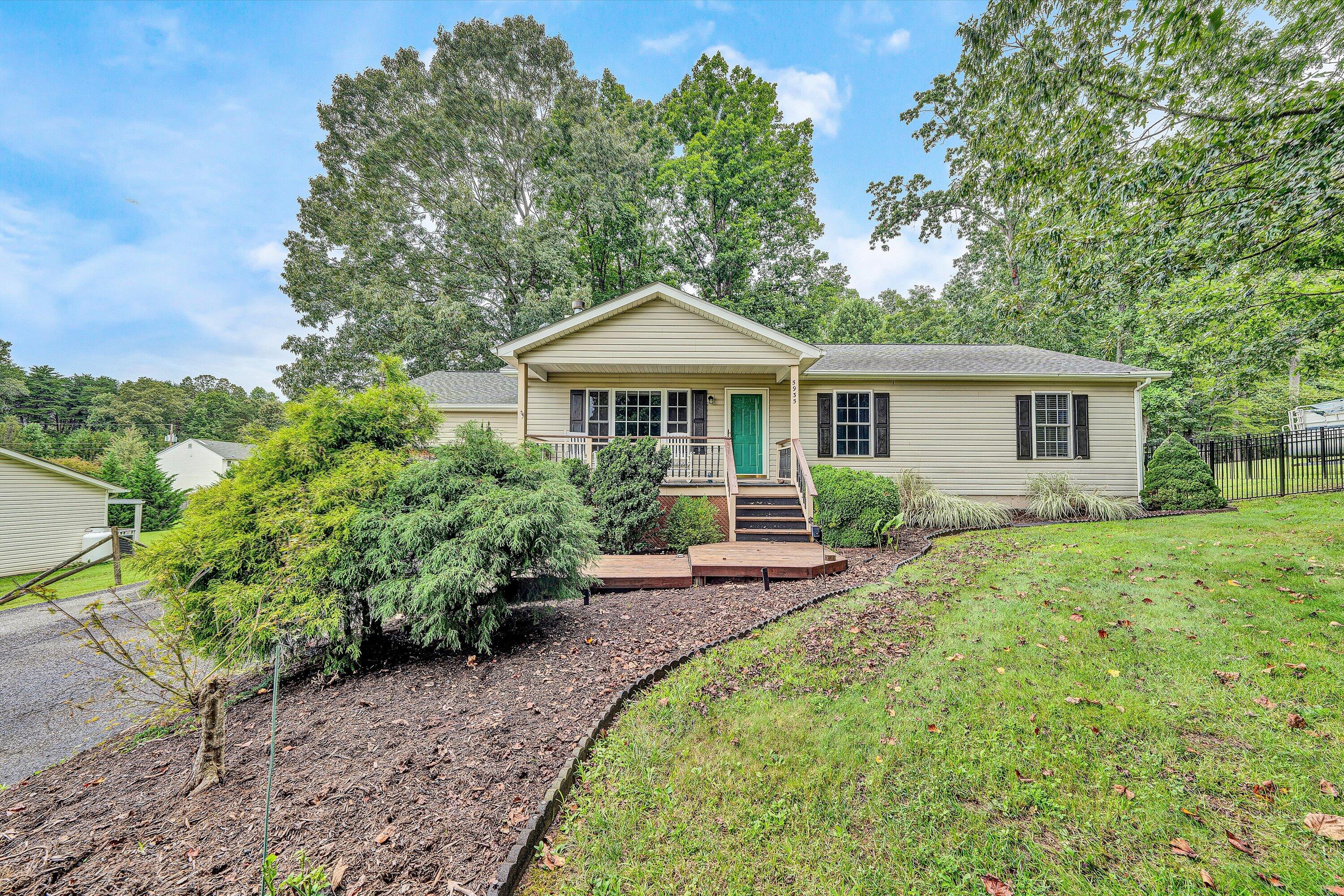 5935 Scruggs Road Moneta, VA 24121 - Photo 1 of 37 a front view of a house with yard patio and green space