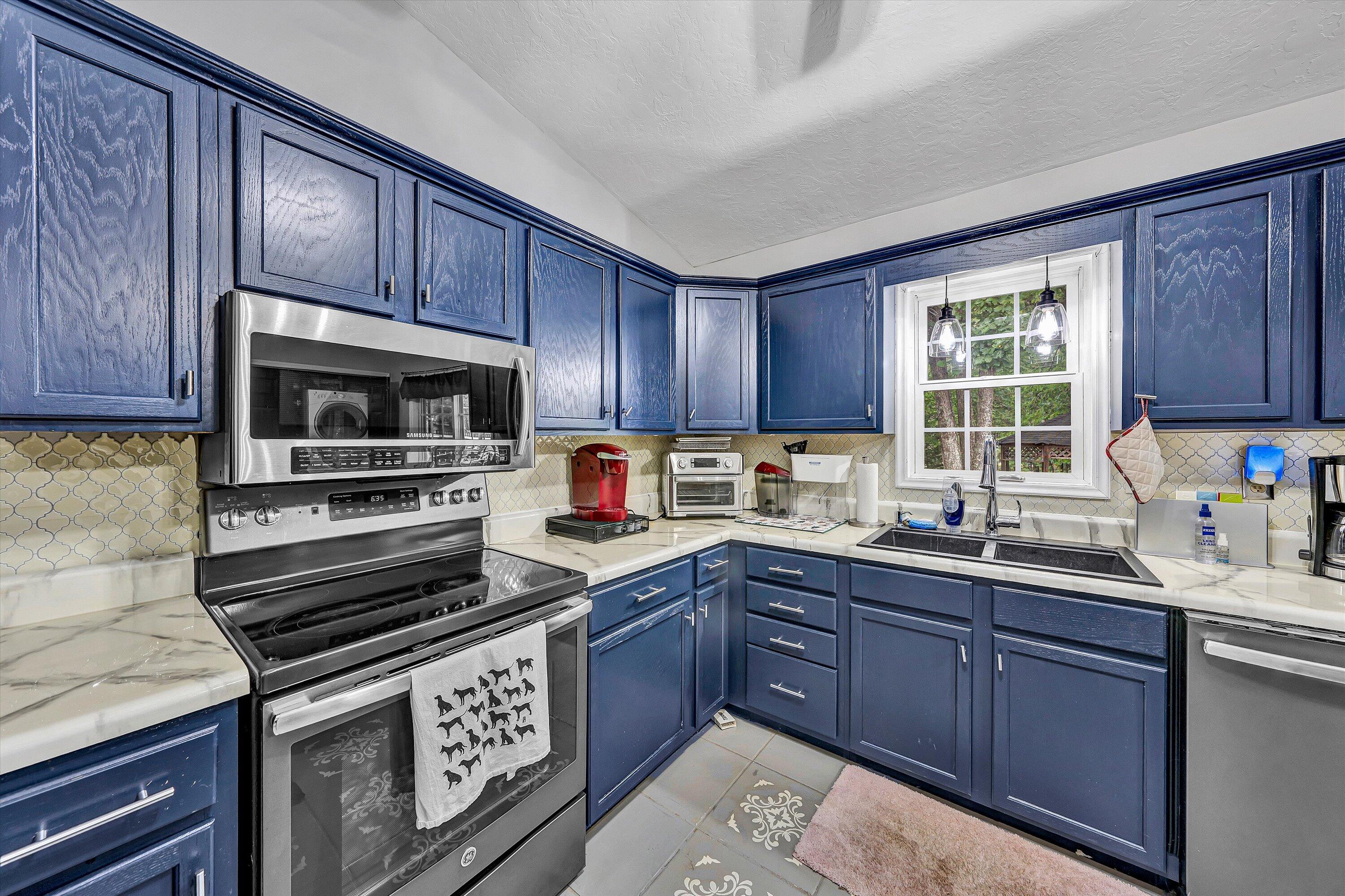 5935 Scruggs Road Moneta, VA 24121 - Photo 11 of 37 a kitchen with sink a microwave a stove and cabinets