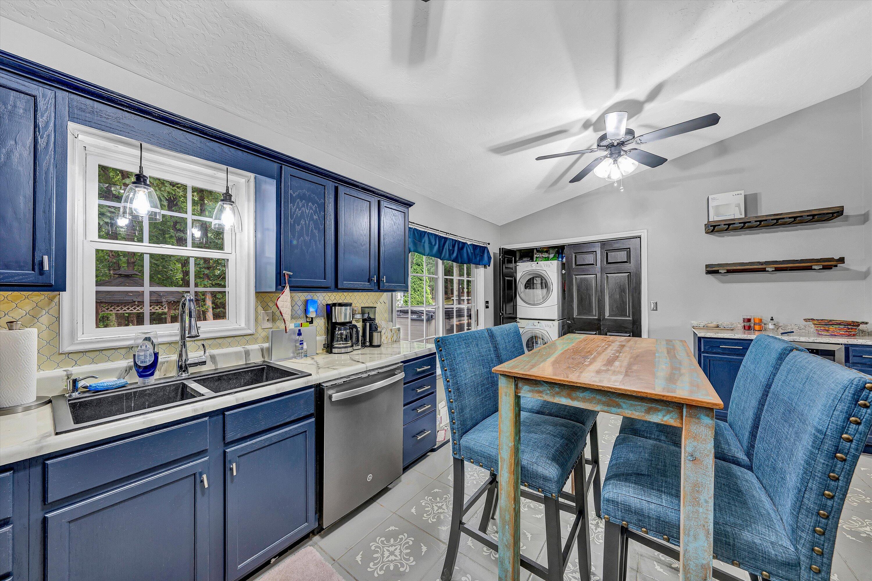 5935 Scruggs Road Moneta, VA 24121 - Photo 12 of 37 a kitchen with a stove a sink a refrigerator dining table and chairs