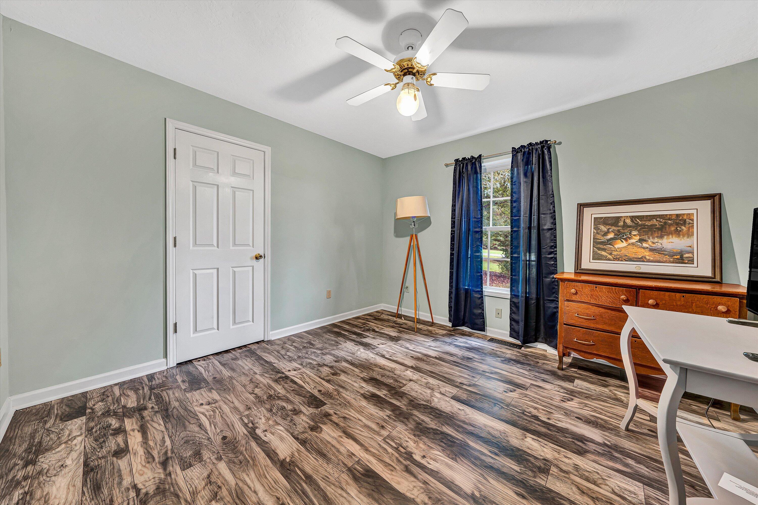 5935 Scruggs Road Moneta, VA 24121 - Photo 14 of 37 a bedroom with a large bed a desk and chair