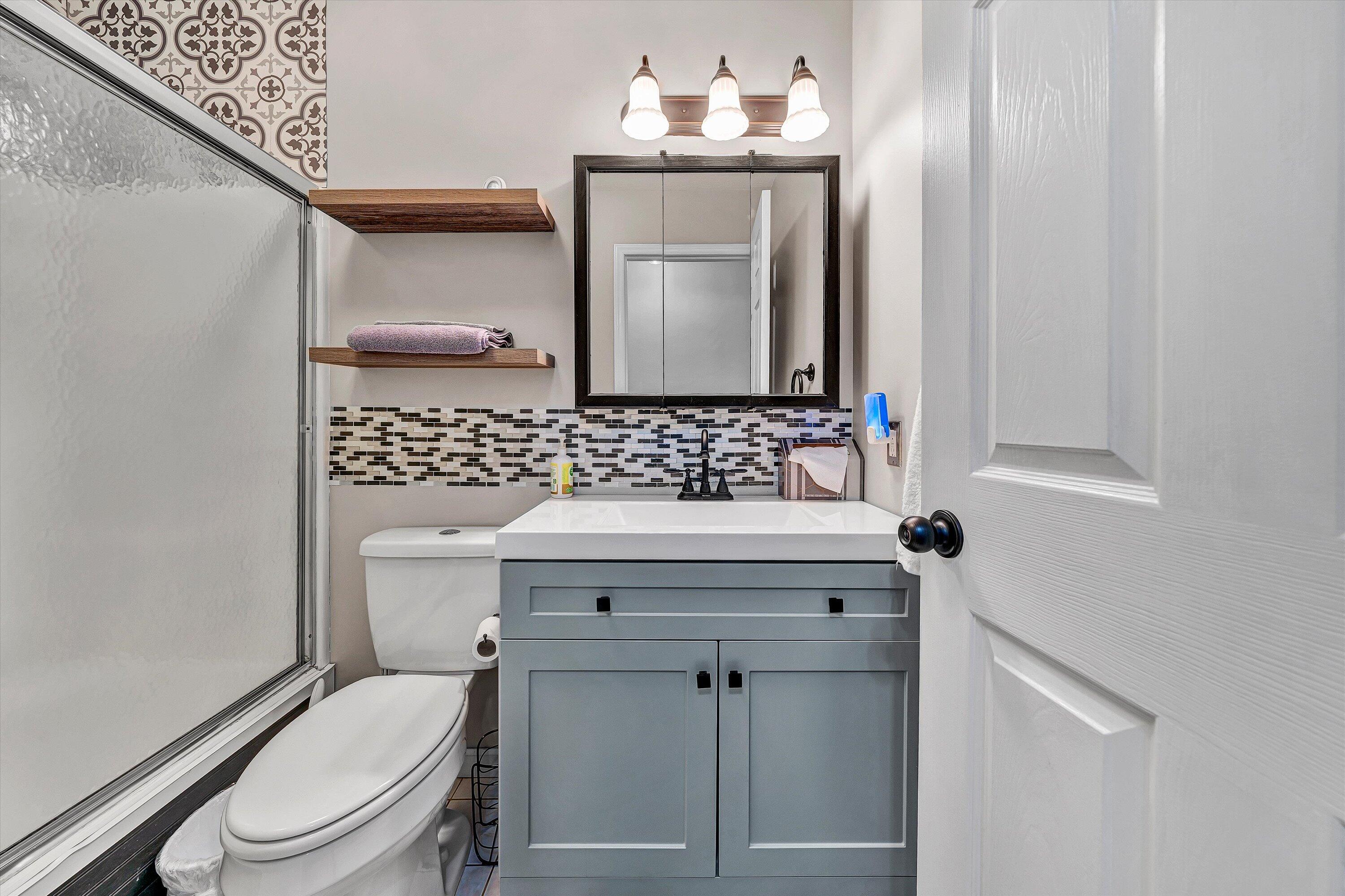 5935 Scruggs Road Moneta, VA 24121 - Photo 15 of 37 a bathroom with a sink a toilet and mirror