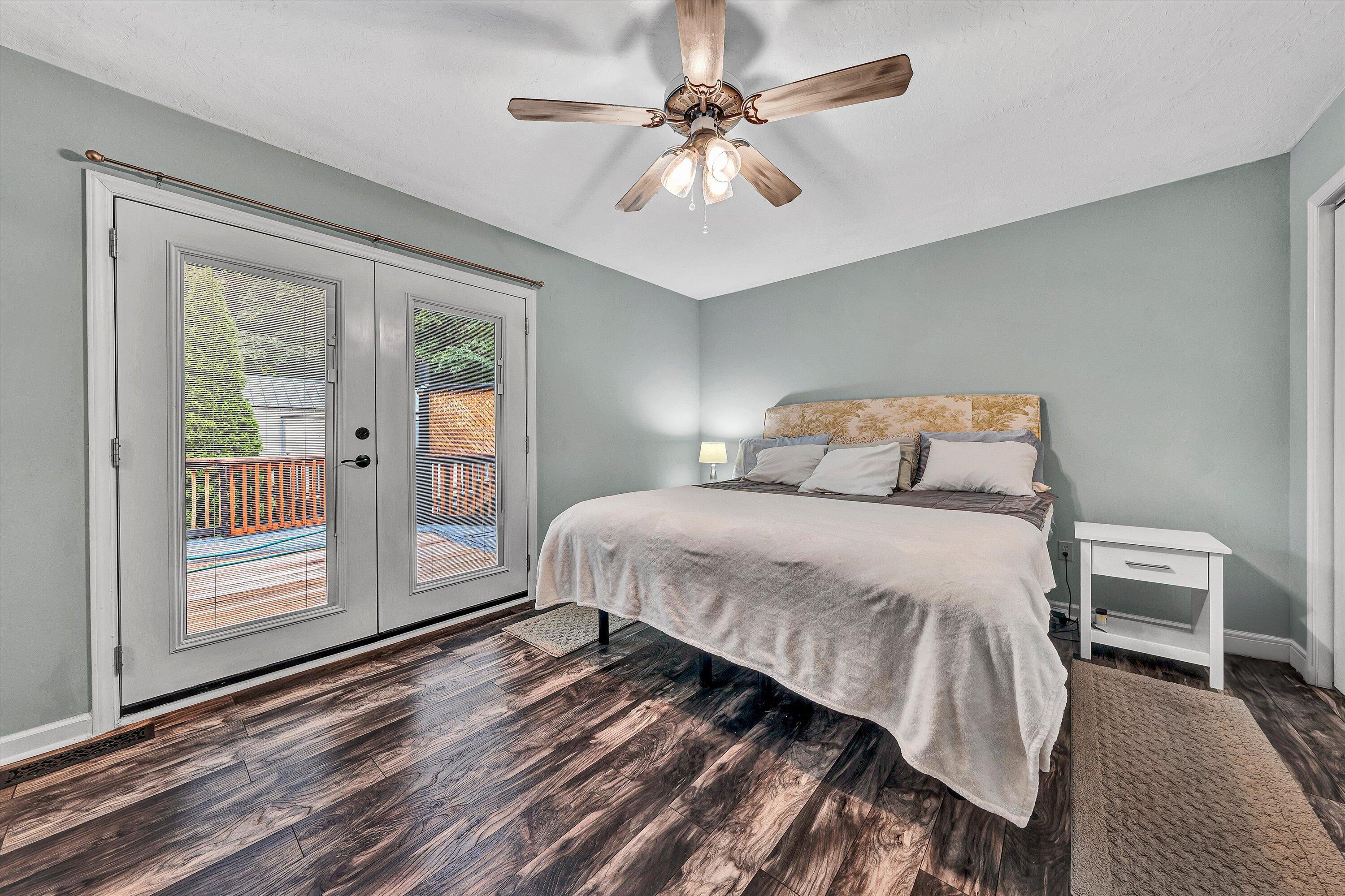 5935 Scruggs Road Moneta, VA 24121 - Photo 16 of 37 a bedroom with a large bed and a chandelier