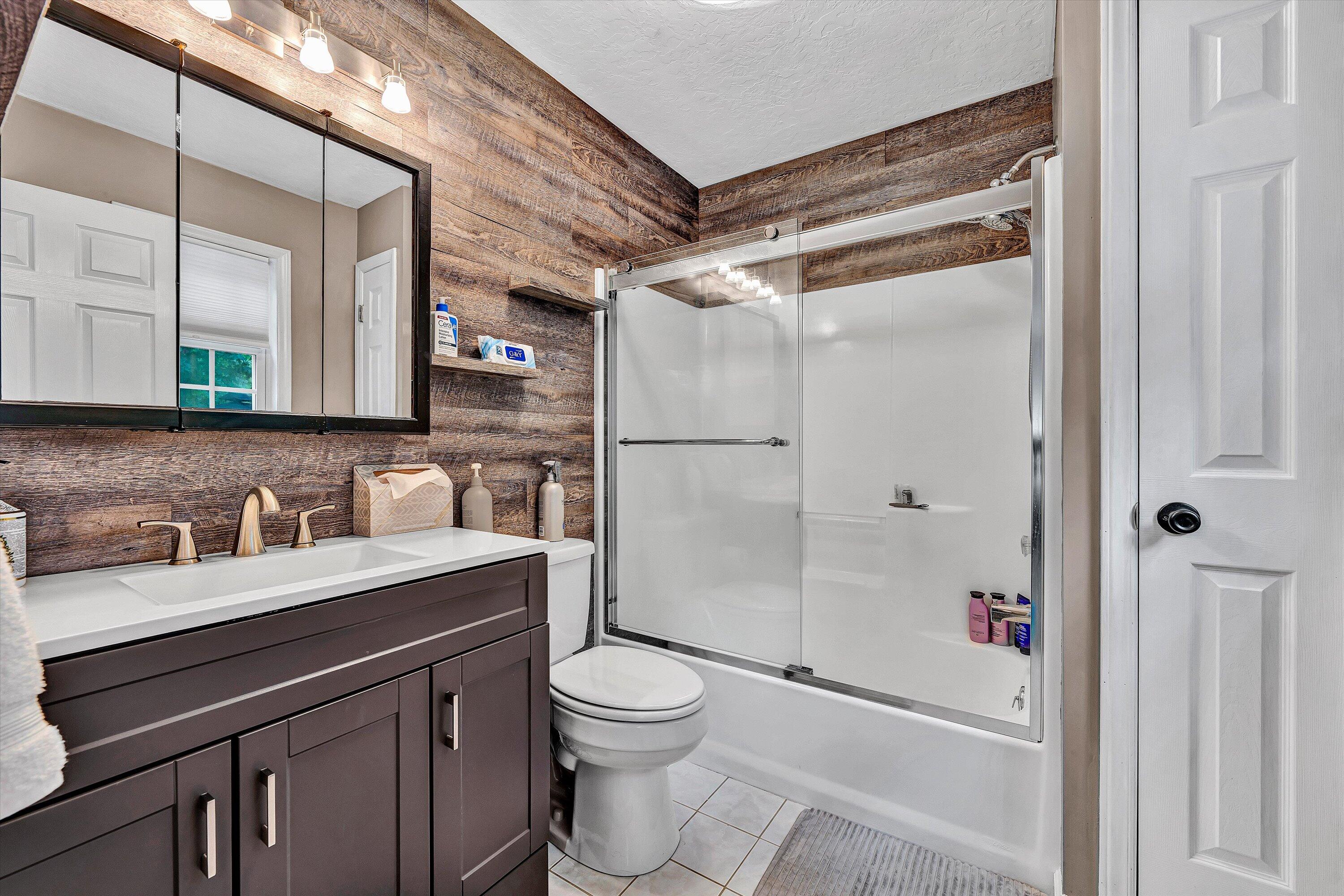 5935 Scruggs Road Moneta, VA 24121 - Photo 18 of 37 a bathroom with a sink a toilet a mirror and shower