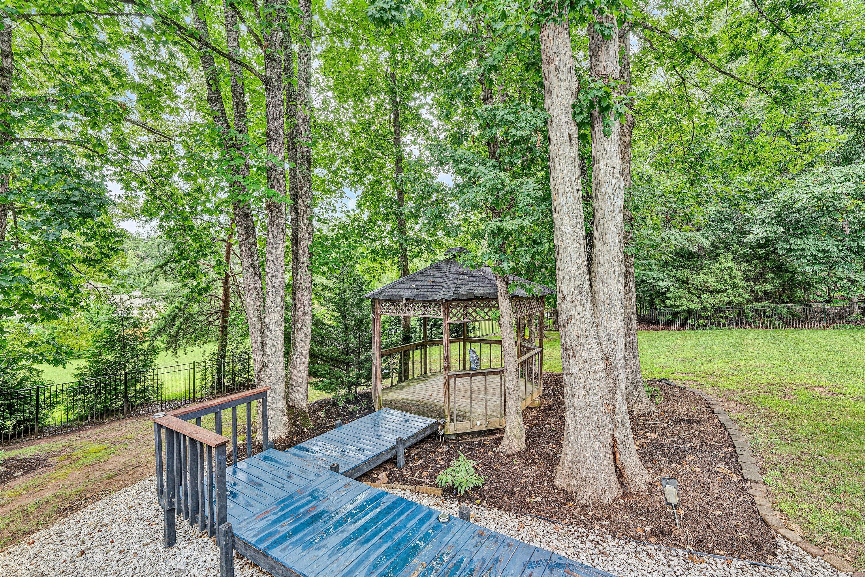 5935 Scruggs Road Moneta, VA 24121 - Photo 27 of 37 a view of a deck with a table chairs and a backyard