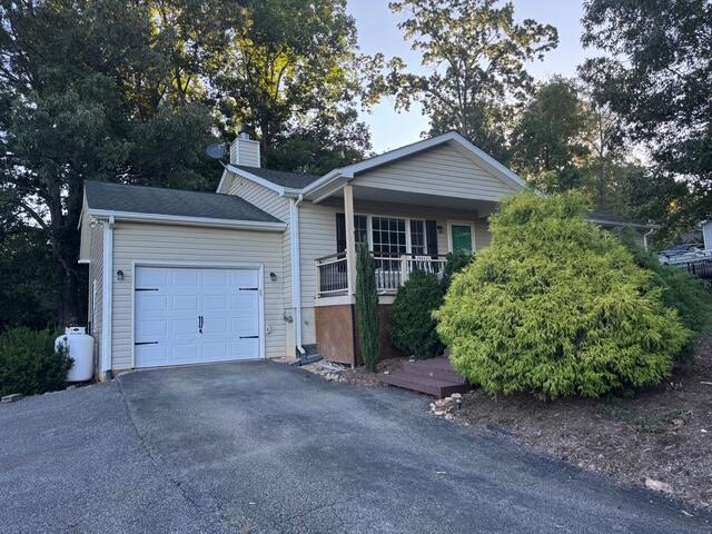 5935 Scruggs Road Moneta, VA 24121 - Photo 3 of 37 a view of a house with a yard and garage