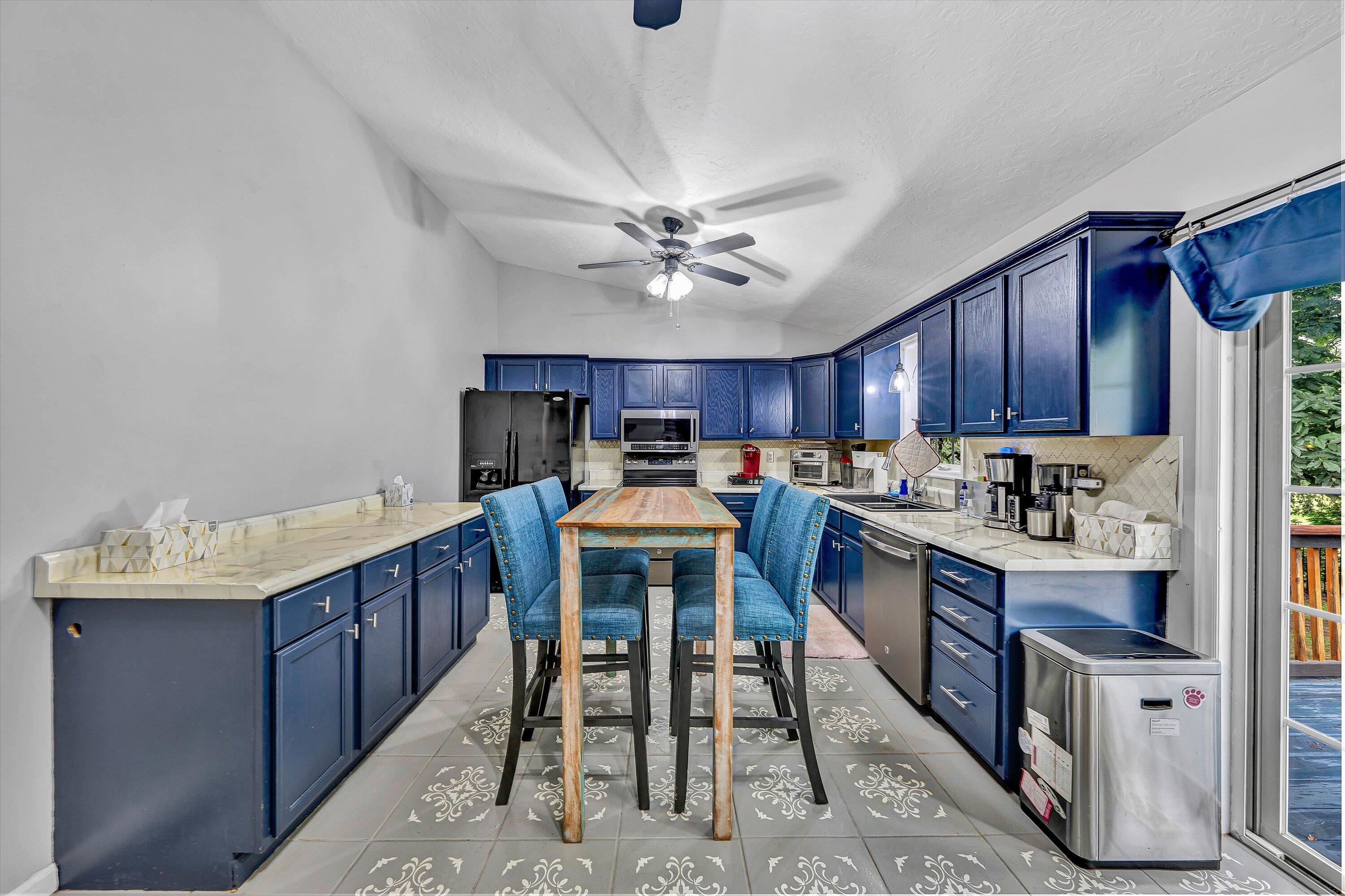 5935 Scruggs Road Moneta, VA 24121 - Photo 10 of 37 a kitchen with kitchen island a dining table chairs cabinets and stainless steel appliances
