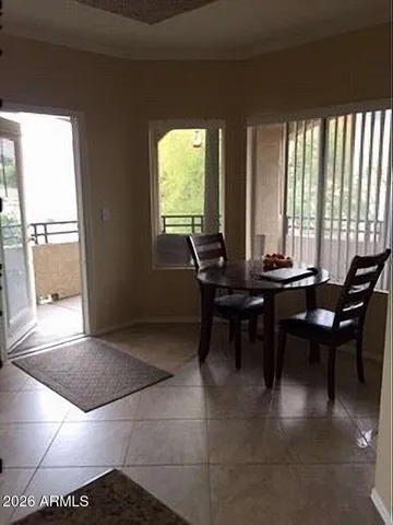 a view of a dining room with furniture and window