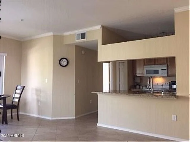a view of kitchen with furniture and a refrigerator