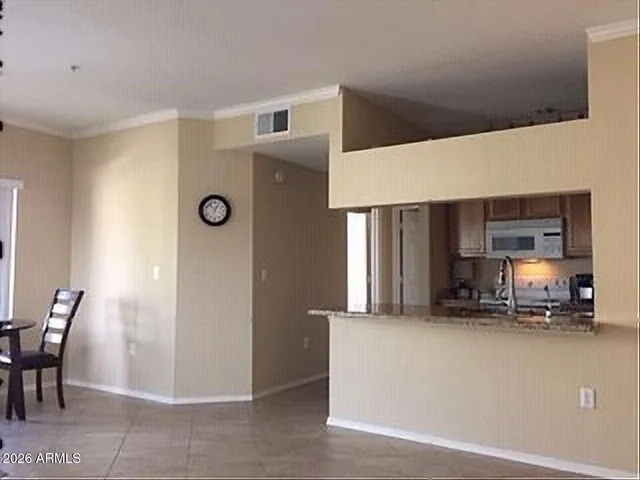 a bathroom with a granite countertop sink and a large mirror next to a large window