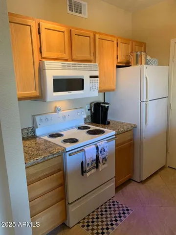 a kitchen with a stove and a refrigerator