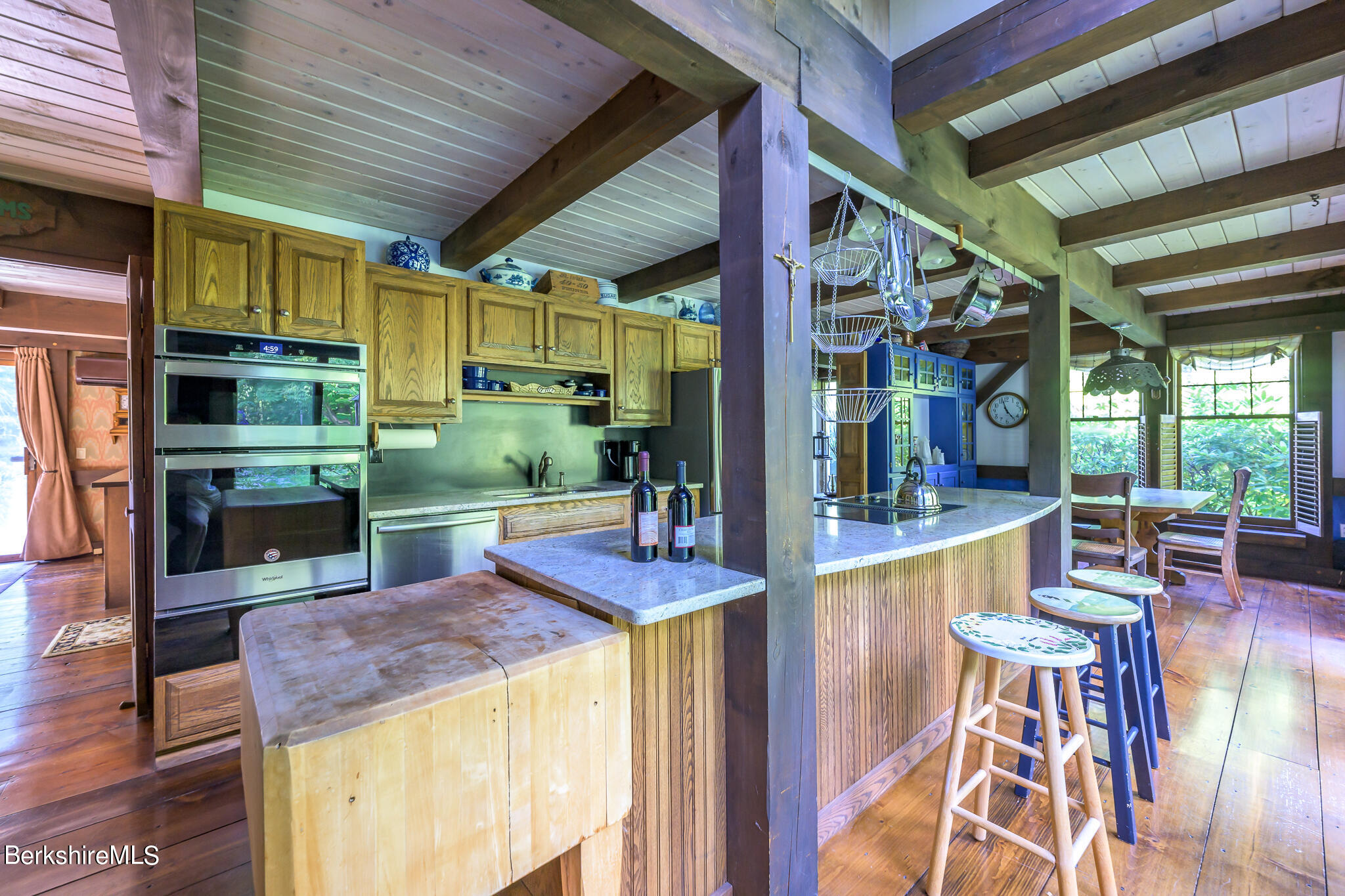 248 Osceola Notch Road Lenox, MA 01254 - Photo 16 of 43 a dining room with stainless steel appliances kitchen island granite countertop a table and chairs in it