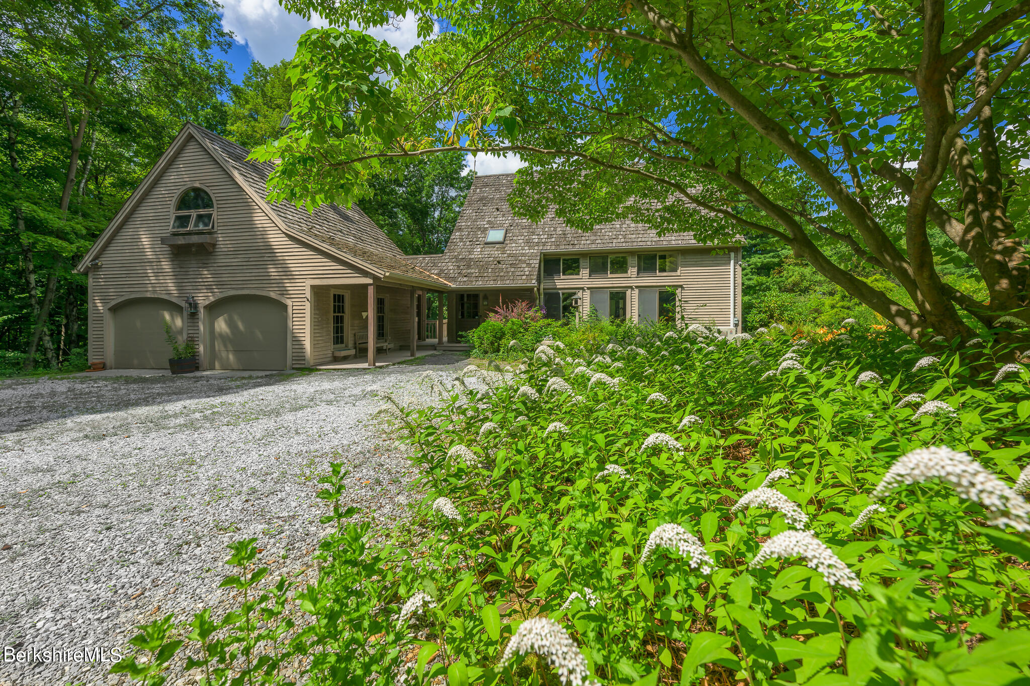248 Osceola Notch Road Lenox, MA 01254 - Photo 36 of 43 a front view of a house with a garden