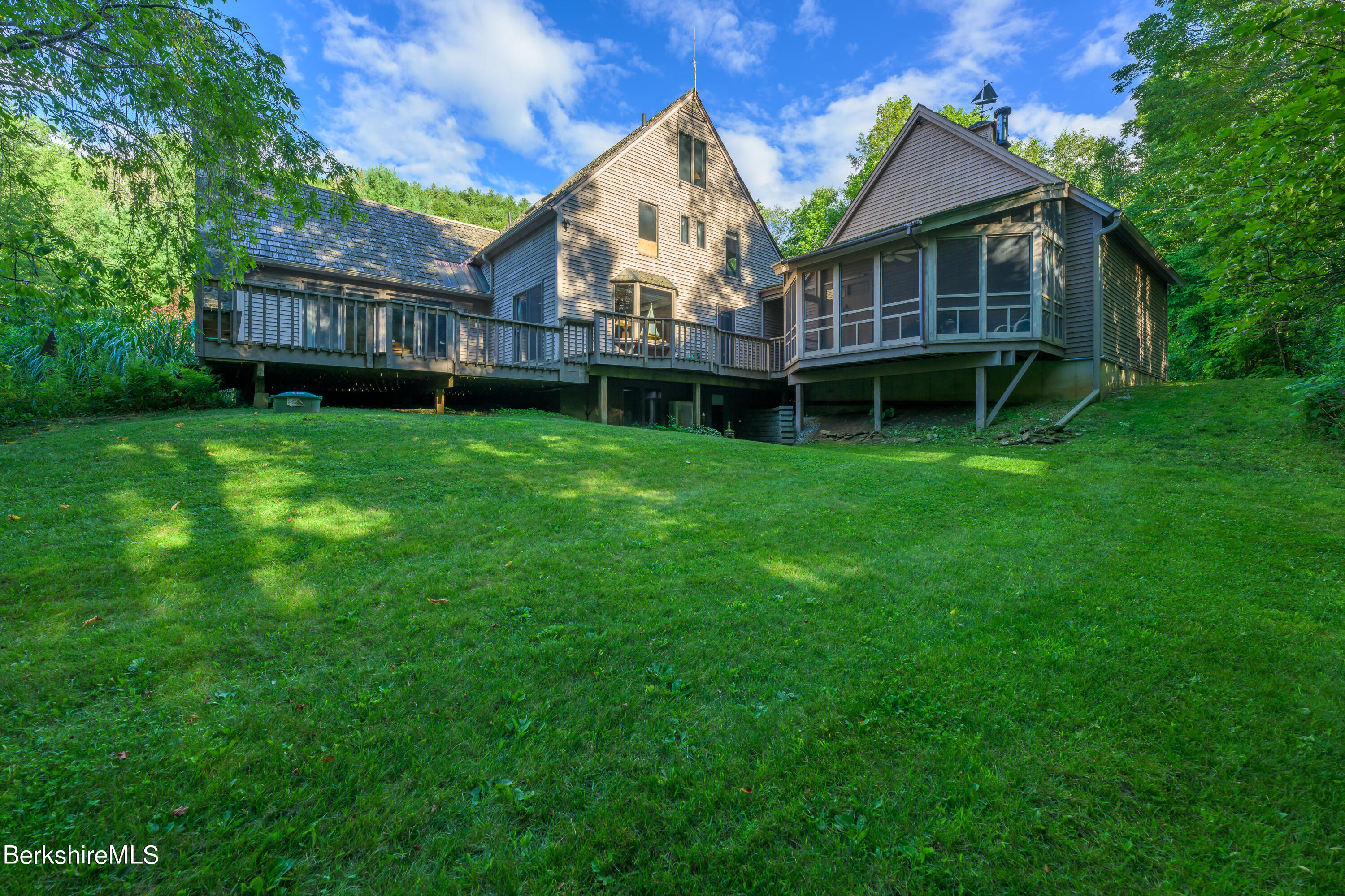 248 Osceola Notch Road Lenox, MA 01254 - Photo 5 of 43 a view of a house with a big yard and large trees