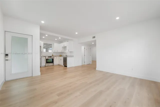 a view of a kitchen with a refrigerator and a sink