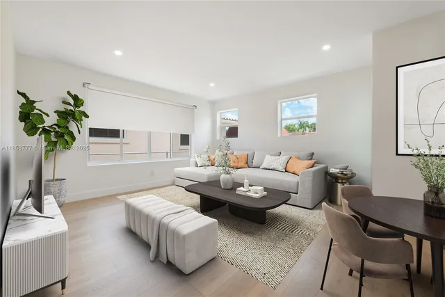 a living room with furniture and a potted plant