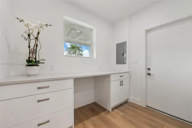 a view of an entryway with wooden floor