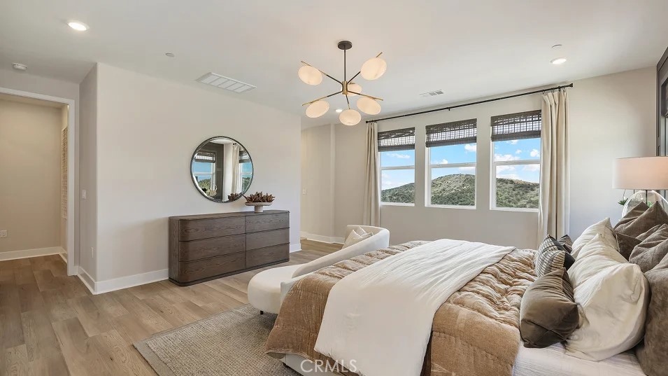 24328 Calle La Roca Valencia, CA 91354 - Photo 13 of 41 a bed room with a bed mirror and a window