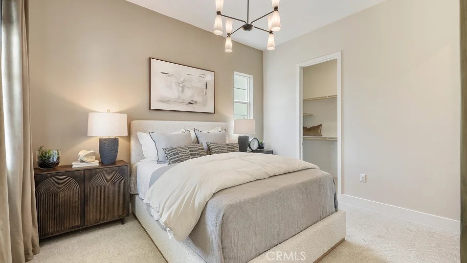 24328 Calle La Roca Valencia, CA 91354 - Photo 24 of 41 a bedroom with a bed and a chandelier