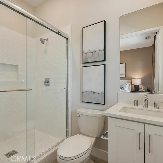 24328 Calle La Roca Valencia, CA 91354 - Photo 26 of 41 a bathroom with a sink a mirror a toilet and shower