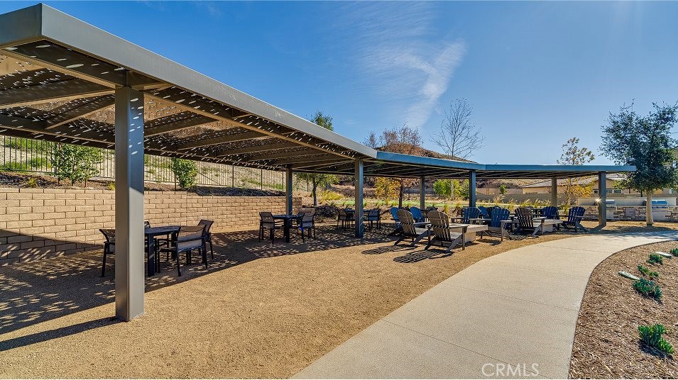 24328 Calle La Roca Valencia, CA 91354 - Photo 32 of 41 a view of a patio with a table and chairs under an umbrella