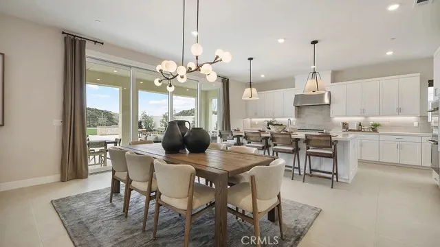 a view of a dining room with furniture and chandelier