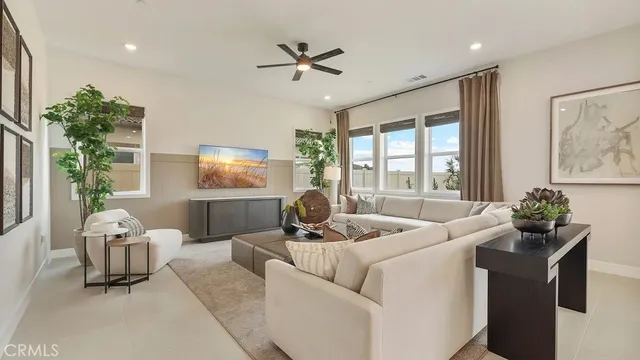 a living room with furniture and kitchen view