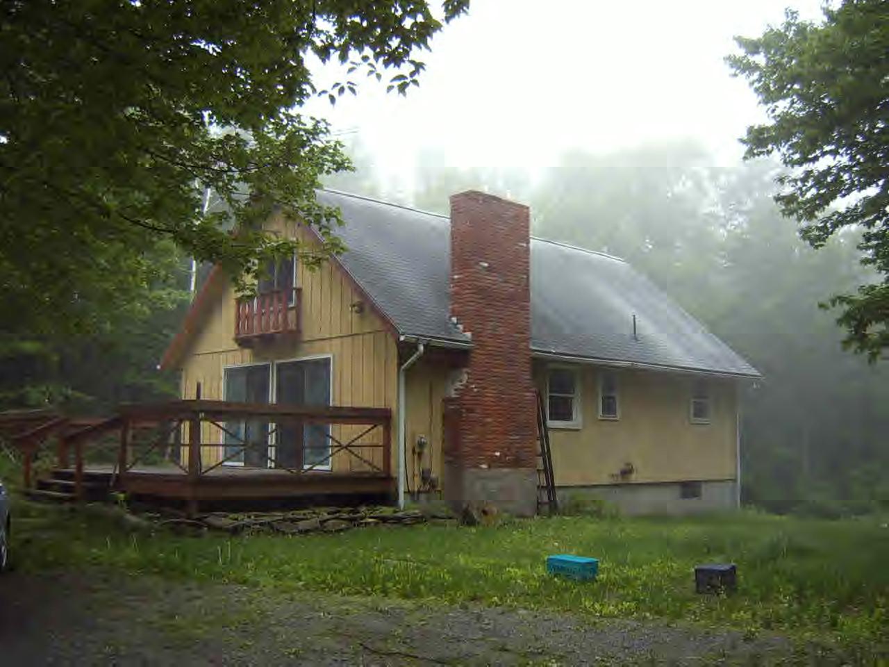 141 Plumb Road Becket, MA 01223 - Photo 1 of 10 a front view of a house with a garden