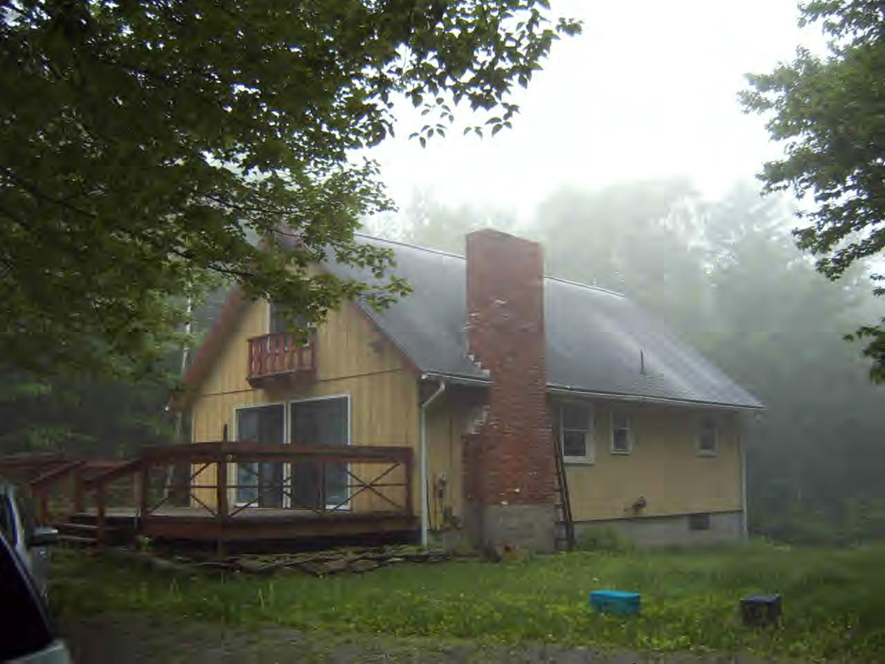 141 Plumb Road Becket, MA 01223 - Photo 10 of 10 a view of house with a yard and a large tree