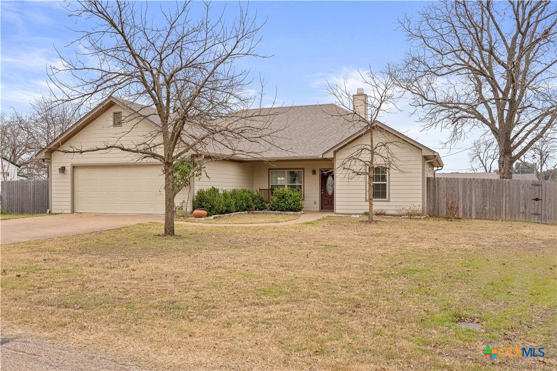 a view of a house with a yard and garage