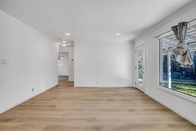 a large kitchen with cabinets and wooden floor