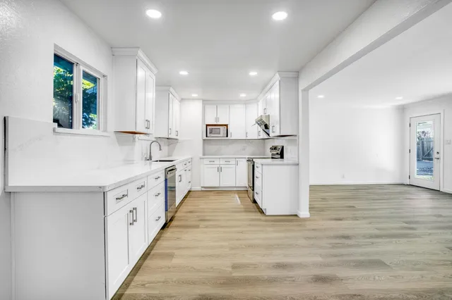 a stove top oven sitting inside of a kitchen