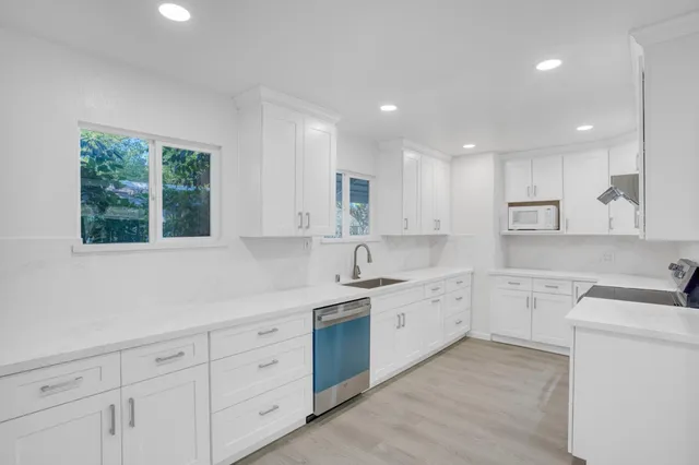 a view of a hallway with wooden floor and entryway