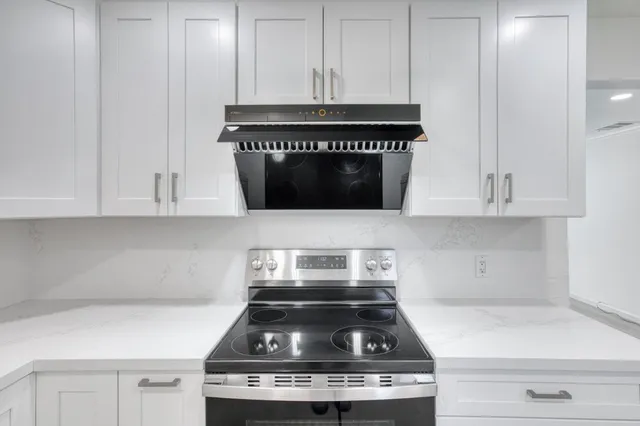 a bathroom with a granite countertop sink a mirror a vanity and a shower