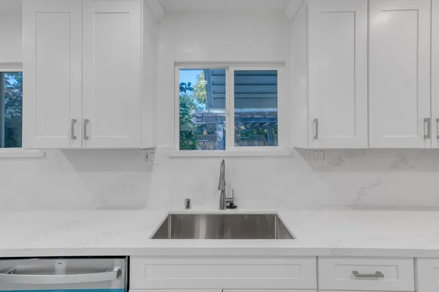 a bathroom with a granite countertop bathtub and a toilet