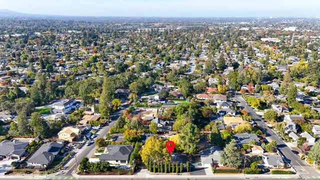 a front view of a house with a yard and potted plants