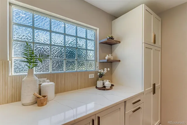 a kitchen with a sink and a potted plant