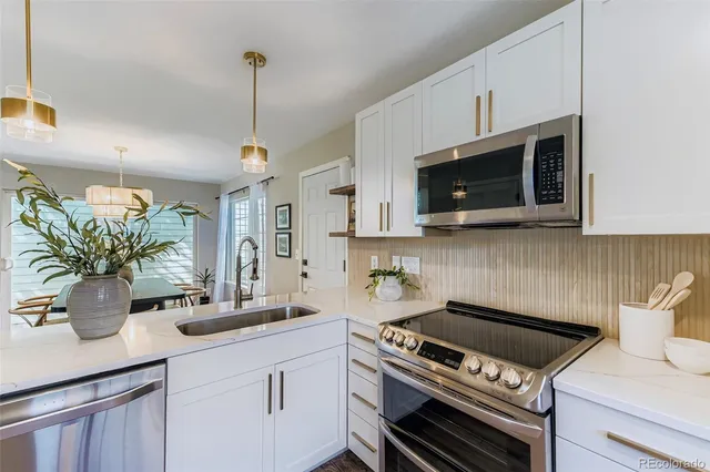 a kitchen with a stove and a white cabinets