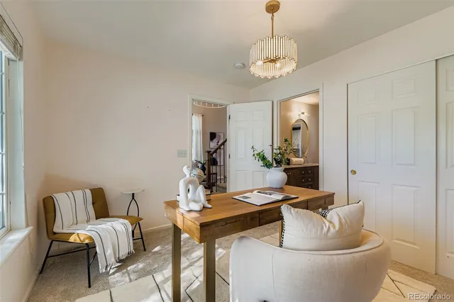a living room with furniture and a chandelier