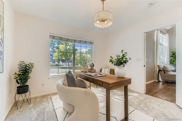 a dining room with furniture potted plants and wooden floor